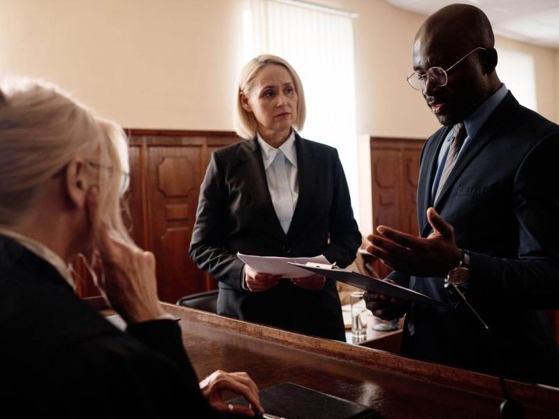 a group of people standing around each other in a courtroom