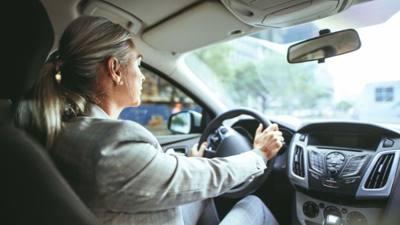 Senior businesswoman driving a car