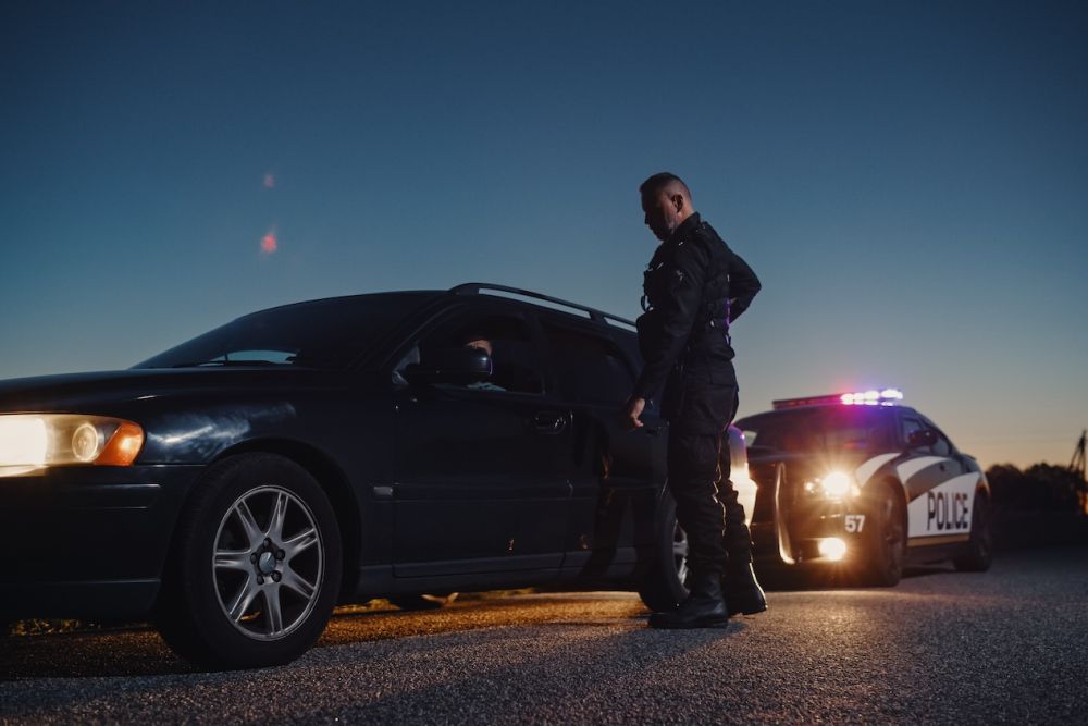 Car Being Stopped by an Officer to Inspect his Papers.