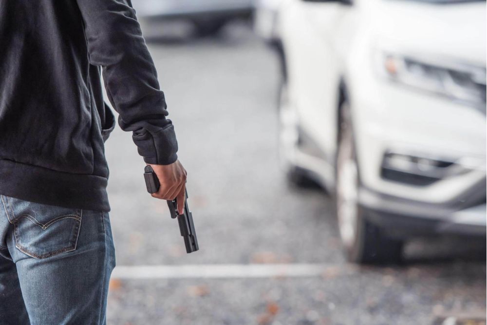 Man brandishing a weapon next to a white