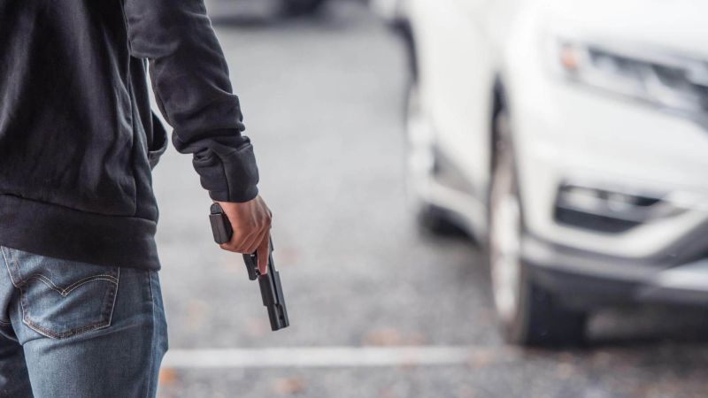 Man brandishing a weapon next to a white