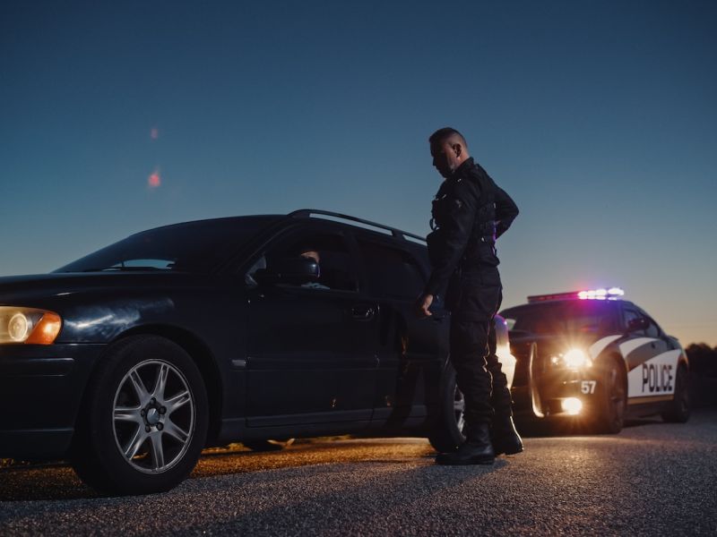 Car Being Stopped by an Officer to Inspect his Papers.
