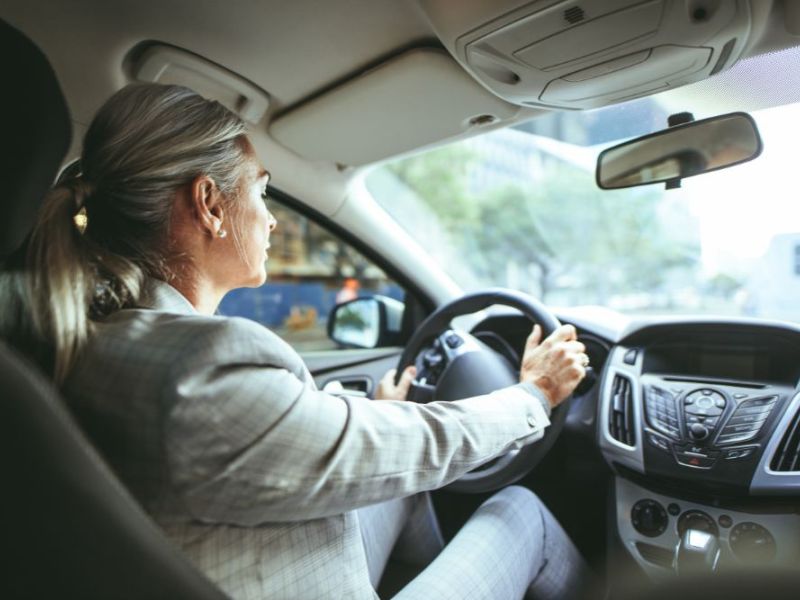 Senior businesswoman driving a car