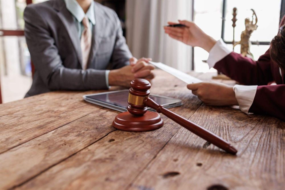 a judge and a person sitting at a table