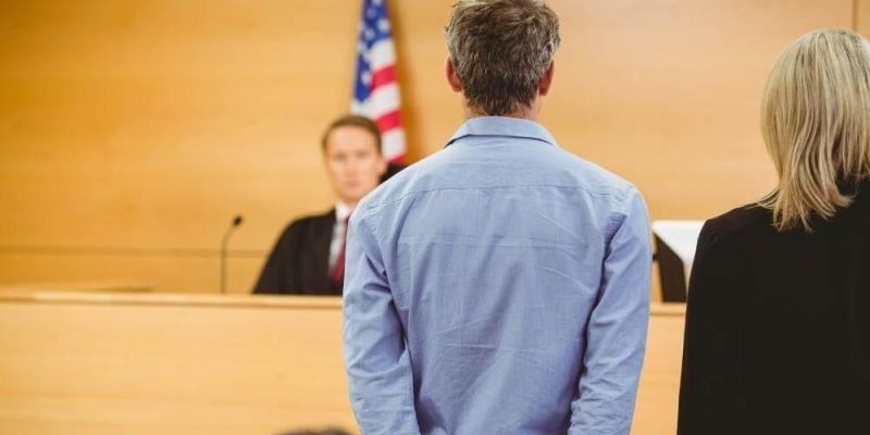 Man and woman with a judge in a
