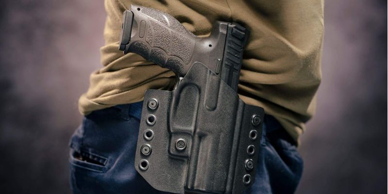 Person holding a handgun closely