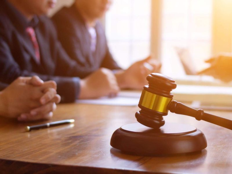 a judge's gavel on a wooden table in a courtroom