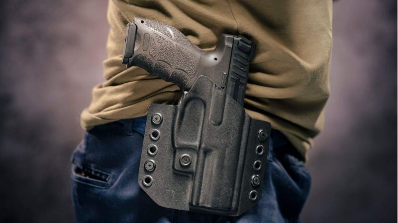 Person holding a handgun closely