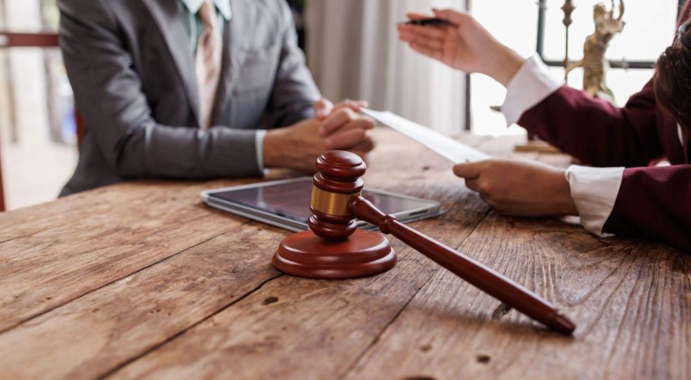 a judge and a person sitting at a table