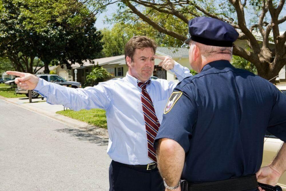 Police officer speaking with a man, possibly regarding