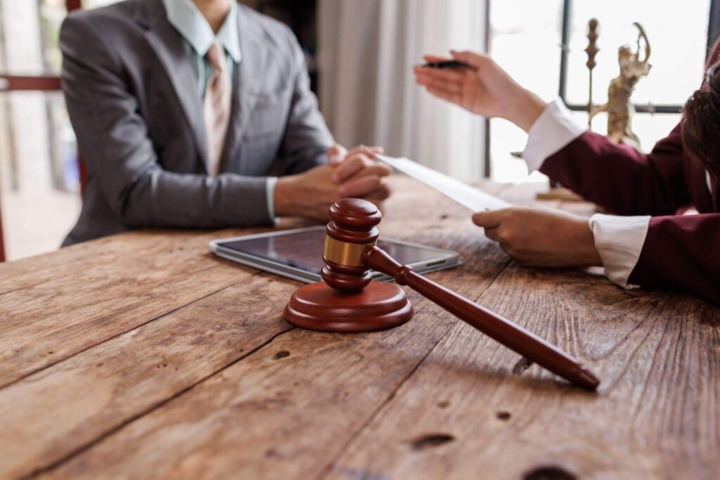 a judge and a person sitting at a table