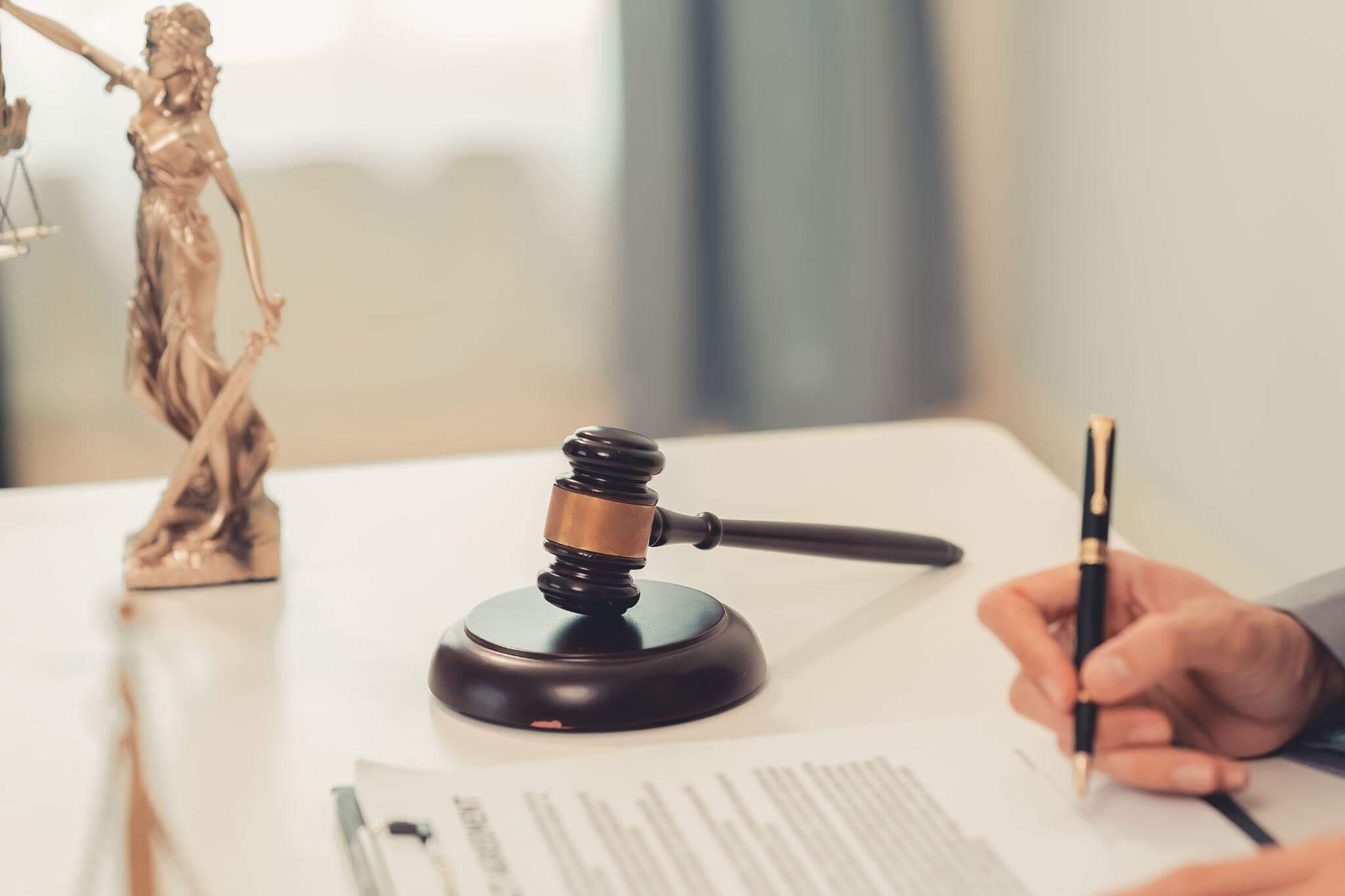 a person sitting at a desk with a pen and paper in front of them