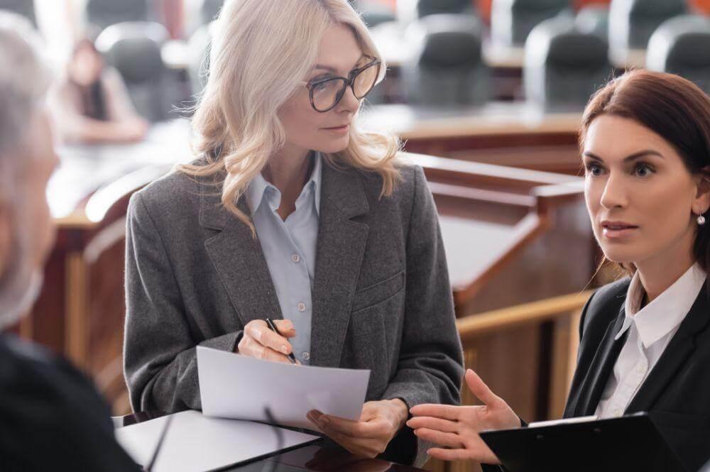 Two women in business suits talking