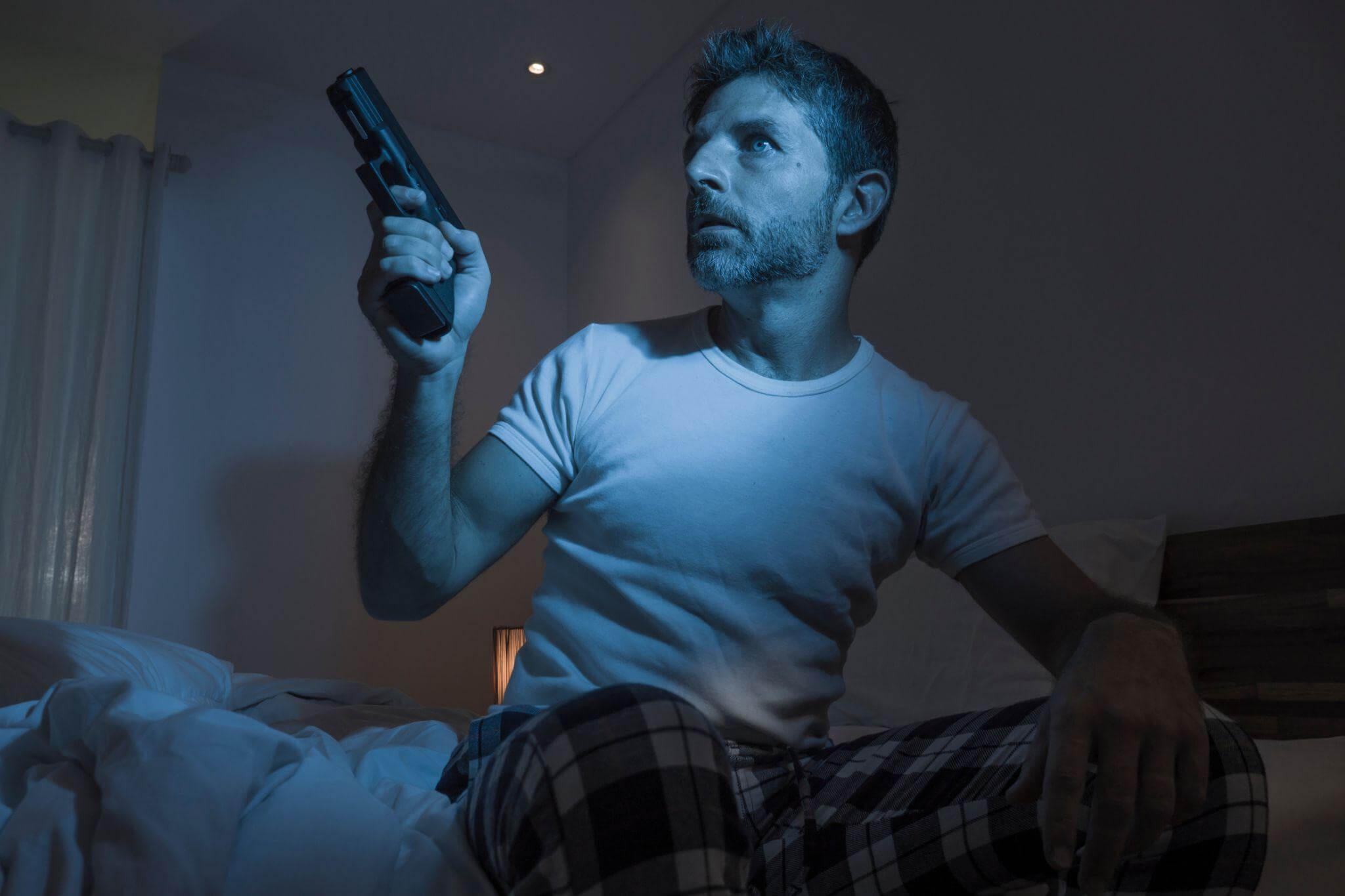 Man sitting on a bed holding a